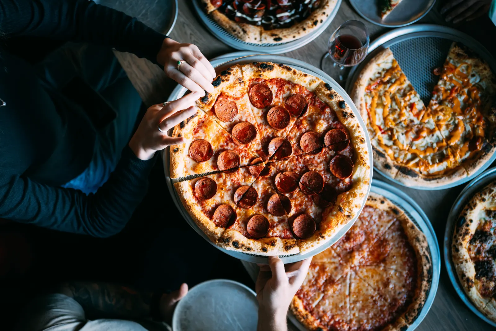 A full table of pizzas, sides and drinks at Mama Said