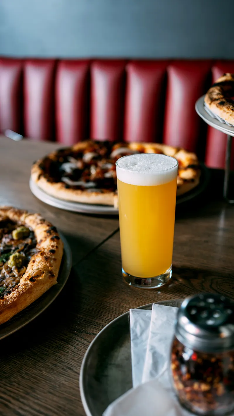 A cold beer and pizza at the booth